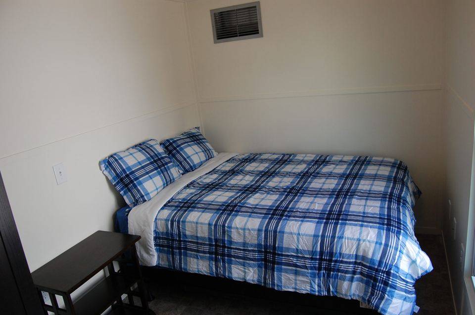 Bedroom with bed and wall vent