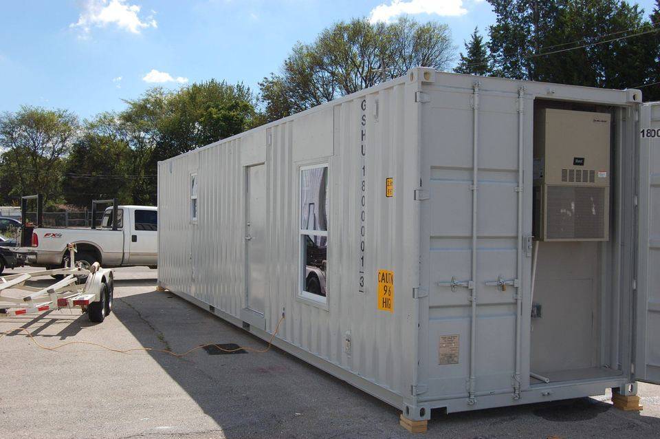 Container unit exterior with wall-mounted HVAC unit and side door