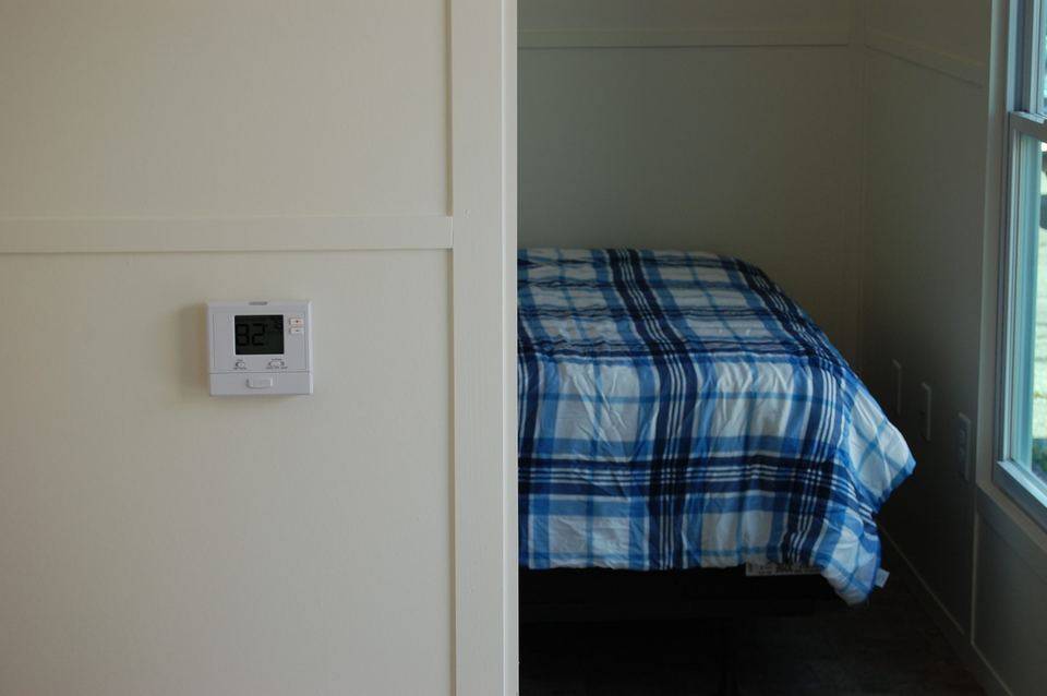 Wall thermostat next to the bed
