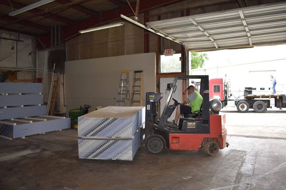 Stacking Drywall in Habitat of Madison County's Facility