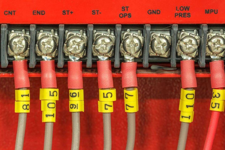 Close-up of labeled wires connected to a terminal block